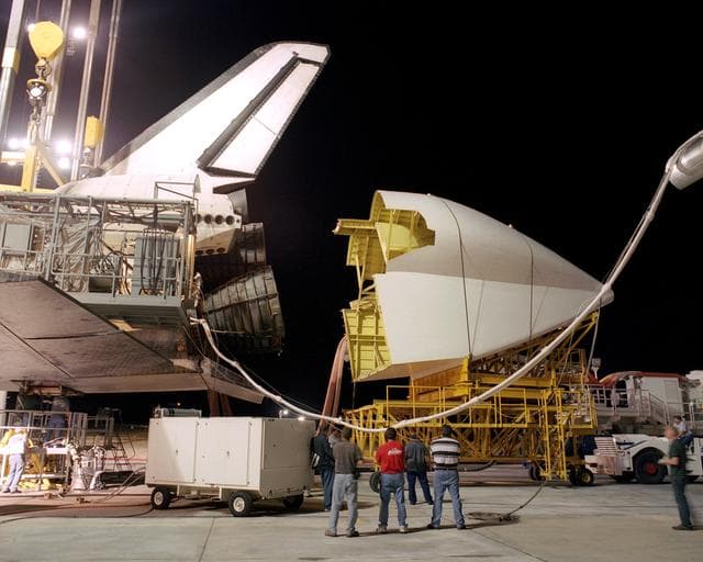 NASA image: Workers position the tail cone on the Space Shuttle Discovery in preparation for its return to NASA's Kennedy Space Center in Florida