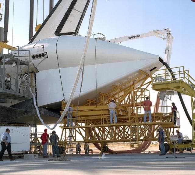 NASA image: Technicians attach the tail cone to the Space Shuttle Discovery in preparation for its return to NASA's Kennedy Space Center in Florida