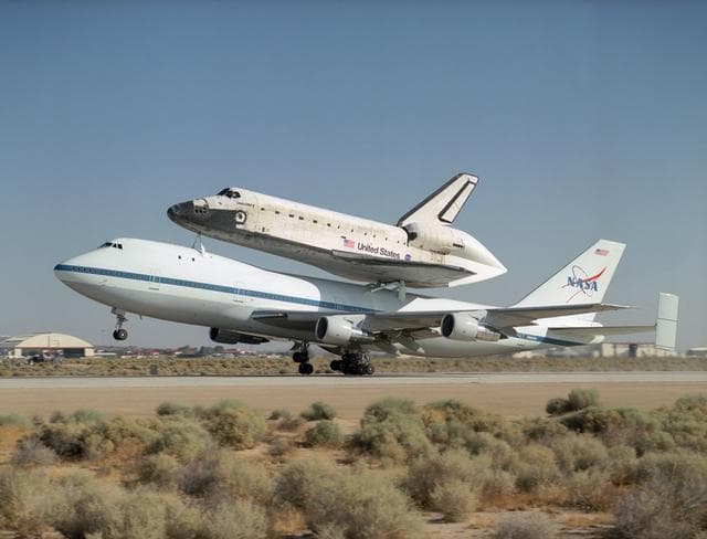NASA image: NASA's 747 Shuttle Carrier Aircraft with the Space Shuttle Discovery on top lifts off to begin its ferry flight back to the Kennedy Space Center in Florida