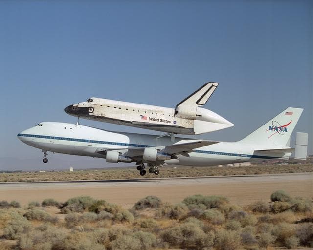 NASA image: NASA's 747 Shuttle Carrier Aircraft with the Space Shuttle Discovery on top lifts off to begin its ferry flight back to the Kennedy Space Center in Florida