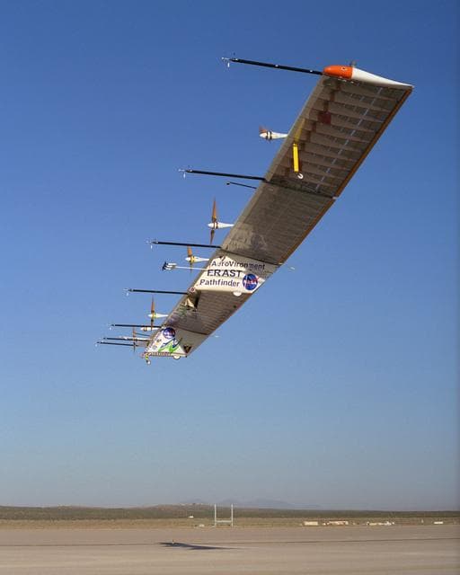 NASA image: The Atmospheric Turbulence Measurement System booms extend forward from the Pathfinder-Plus solar wing as it soars over Rogers Dry Lake.