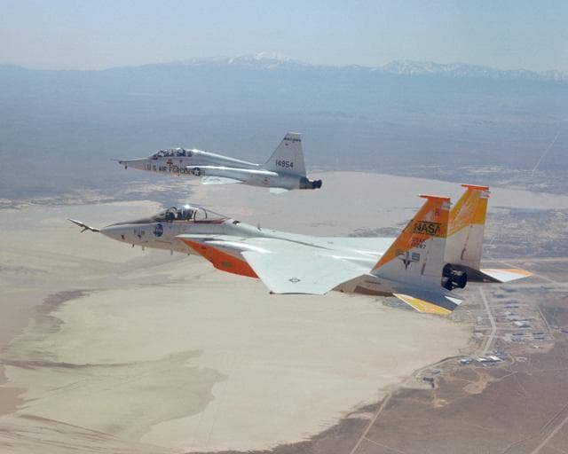 NASA image: F-15A #287 flies formation with a T-38 chase over Edwards AFB.