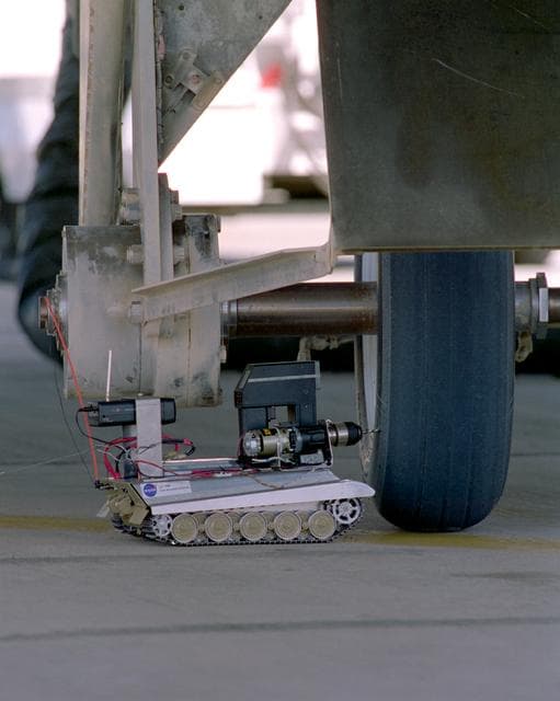 NASA image: CV-990 Landing Systems Research Aircraft (LSRA) flight #145 drilling of shuttle tire using Tire Assault Vehicle