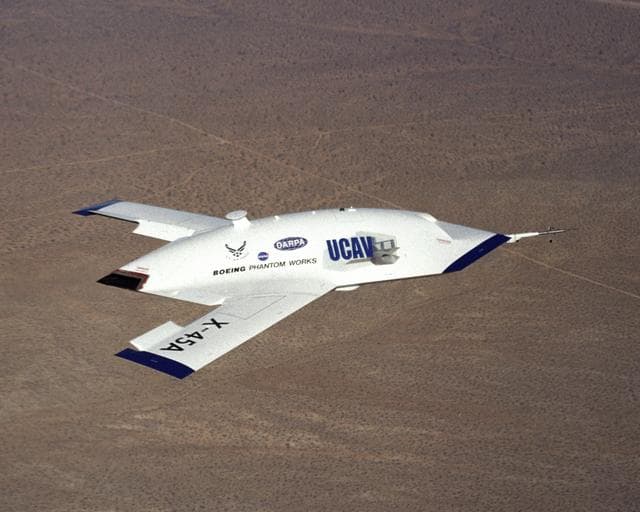 NASA image: X-45A in flight with F-18 #846 chase aircraft, during first GPS-guided weapon demonstration flight