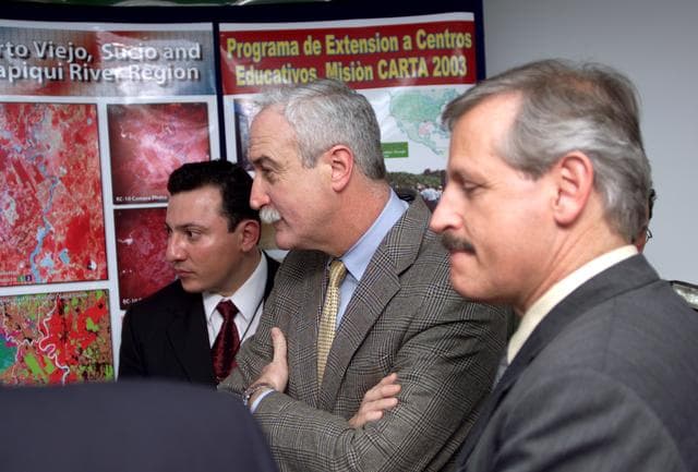 NASA image: Personnel viewing posters showing how NASA activities have made an impact on Costa Rican people