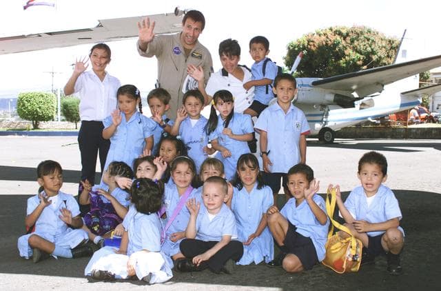 NASA image: NASA Dryden Mission Manager Walter Klein poses with school children that visited the airport during AirSAR 2004