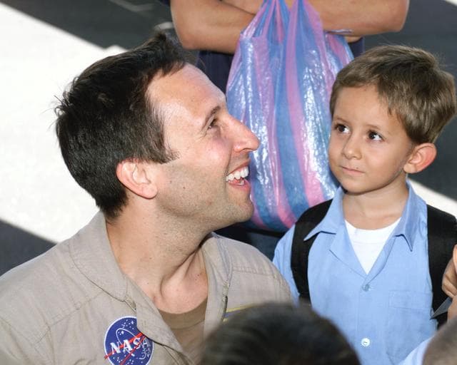 NASA image: DFRC Mission Manager Walter Klein passes out stickers and lithographs to underprivileged Costa Rican school children that visited the airport on Monday March 8, 2004