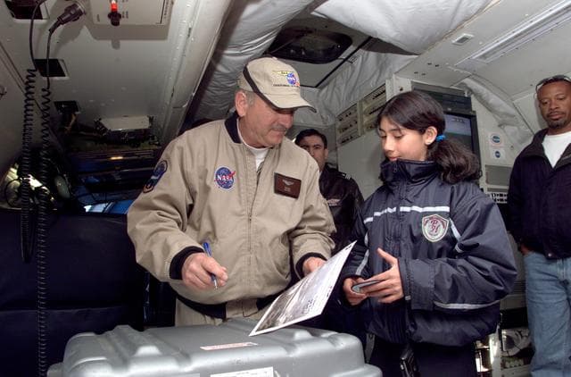 NASA image: Dr. Tom Mace talks with a student from Punta Arenas, Chile, during a tour of the DC-8 aircraft