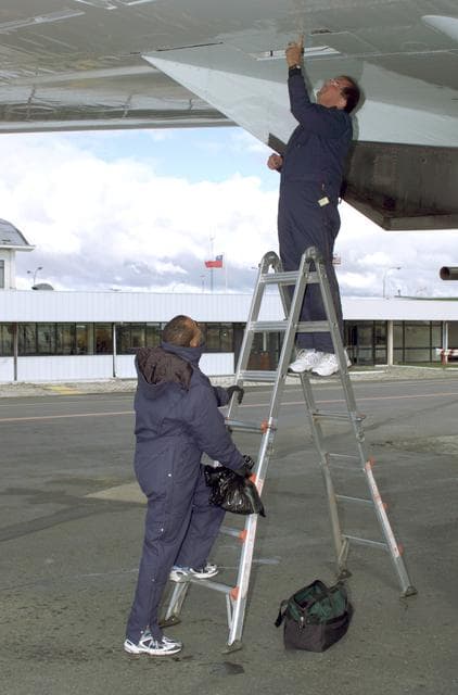 NASA image: NASA DC-8 Ground Support Technicians Mark Corlew and Mike Lakowski perform routine maintenance on the aircraft in Punta Arenas, Chile