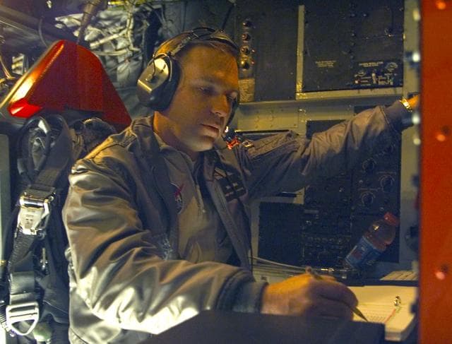 NASA image: NASA's Brad Neal, X-43A Monitor Station Operator aboard NASA's B-52B mothership, performing pre-flight checks on November 16, 2004