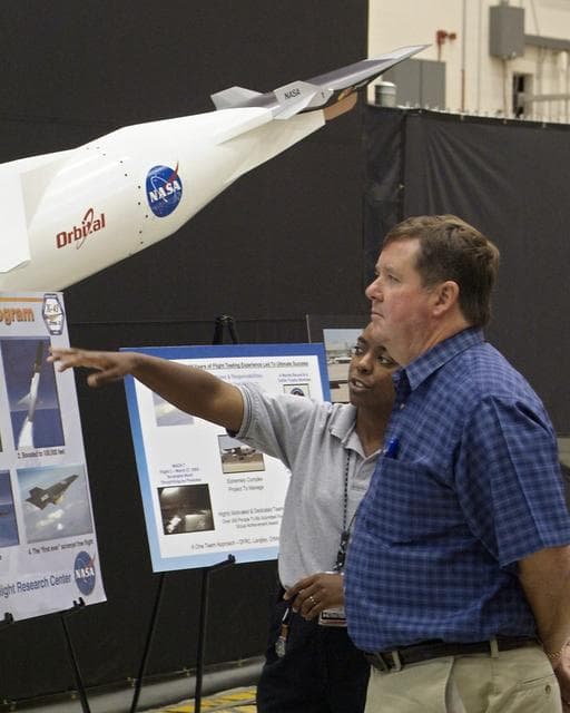 NASA image: Rep. Ken Calvert, R-Calif., chairman of the House Subcommittee on Space and Aeronautics, was briefed by X-43A engineer Laurie Grindle during his tour of Dryden