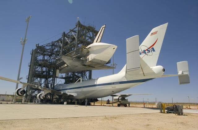 NASA image: NASA's modified 747 Shuttle Carrier Aircraft is positioned under the Space Shuttle Discovery to be attached for their ferry flight to the Kennedy Space Center