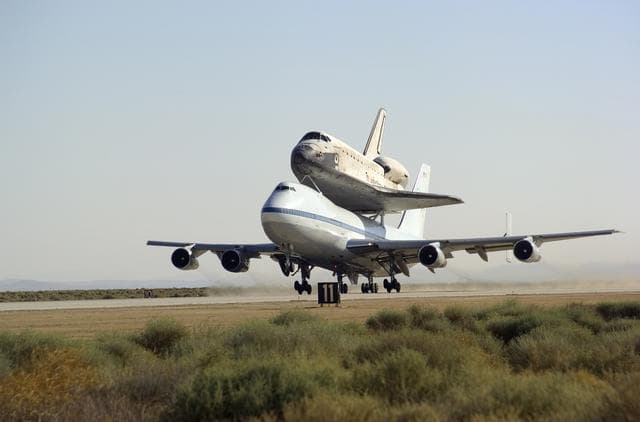 NASA image: NASA's 747 Shuttle Carrier Aircraft with the Space Shuttle Discovery on top lifts off to begin its ferry flight back to the Kennedy Space Center in Florida