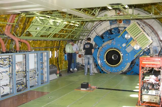 NASA image: Technicians check out the mounting structure of the infrared telescope installed in NASA's Stratospheric Observatory for Infrared Astronomy (SOFIA)