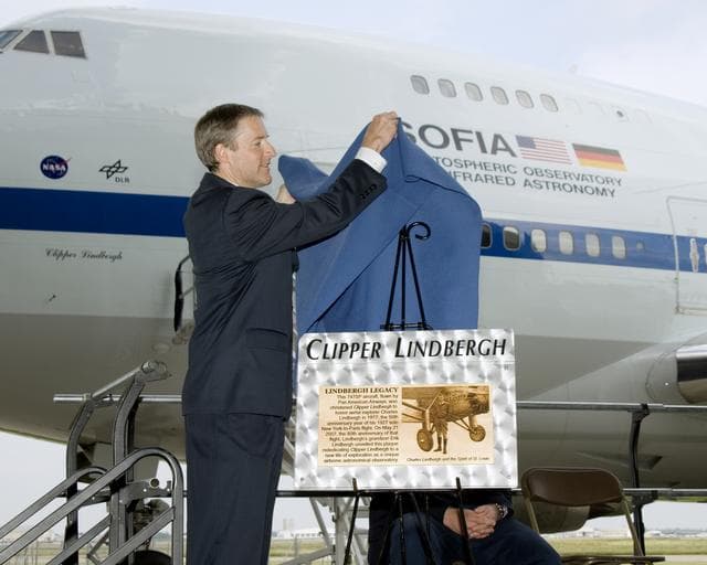 NASA image: Erik Lindbergh unveils a plaque commemorating his grandfather to dedicate the 747 Clipper Lindbergh, a NASA airborne infrared observatory known as SOFIA
