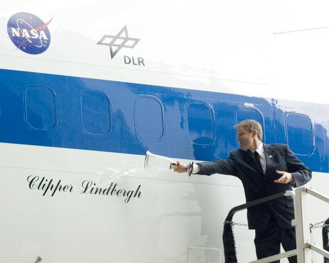 Erik Lindbergh christens NASA's 747 Clipper Lindbergh with a special commemorative concoction representing local, NASA, and industry partners