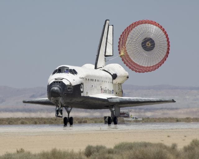 NASA image: The Space Shuttle Atlantis' drag chute deploys as it rolls out on Runway 22 at Edwards AFB at the conclusion of its 13-day STS-117 mission to the ISS