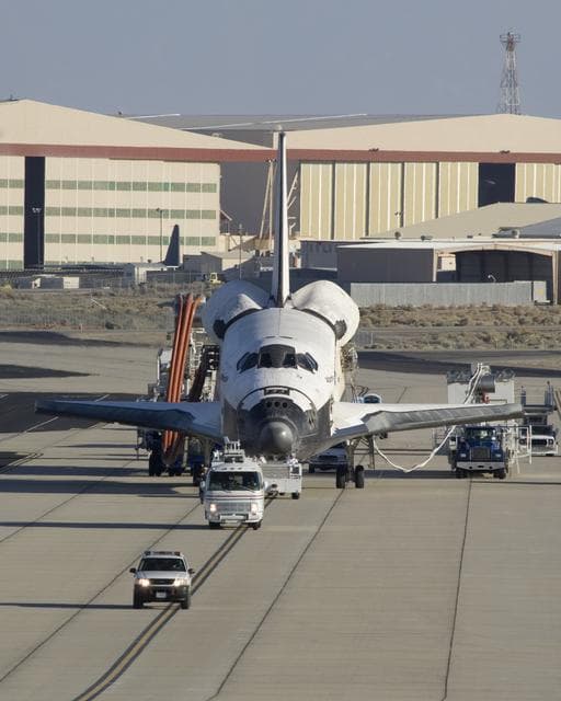 NASA image: Accompanied by a convoy of recovery vehicles, the Space Shuttle Atlantis is towed up the taxiway at NASA Dryden following its landing on June 22, 2007