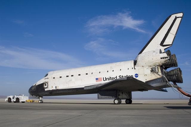 NASA image: The Space Shuttle Atlantis is towed from the runway at Edwards Air Force Base to NASA Dryden's Mate-Demate Device (MDD) for post-flight processing
