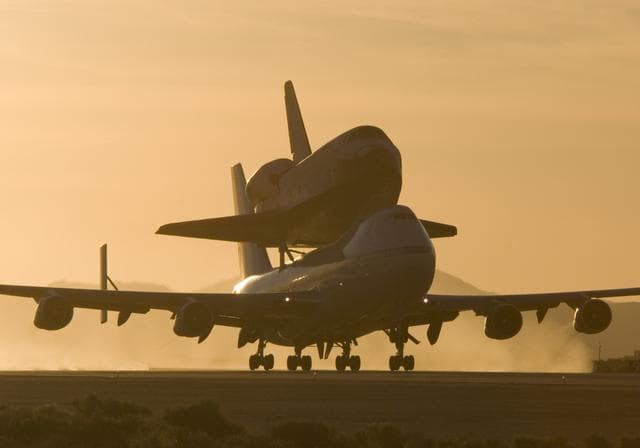 NASA image: NASA's 747 Shuttle Carrier Aircraft with the Space Shuttle Atlantis on top lifts off to begin its ferry flight back to the Kennedy Space Center in Florida
