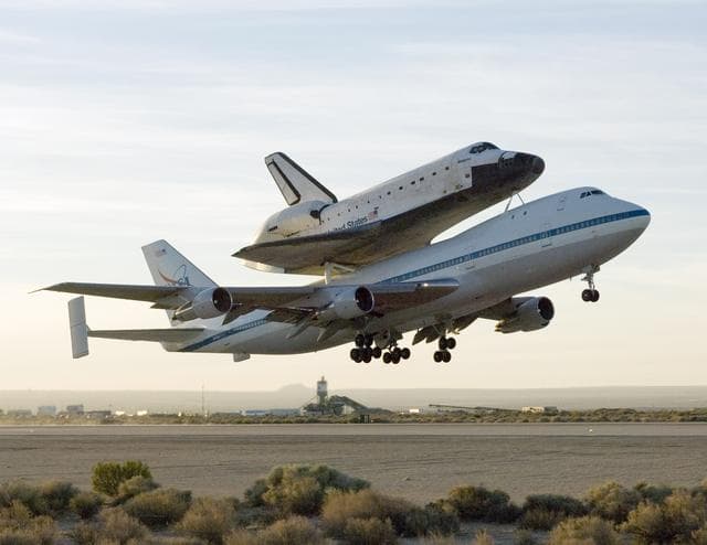 NASA image: NASA's 747 Shuttle Carrier Aircraft with the Space Shuttle Atlantis on top lifts off to begin its ferry flight back to the Kennedy Space Center in Florida