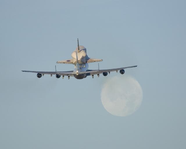 NASA image: NASA's 747 Shuttle Carrier Aircraft with the Space Shuttle Atlantis on top lifts off to begin its ferry flight back to the Kennedy Space Center in Florida
