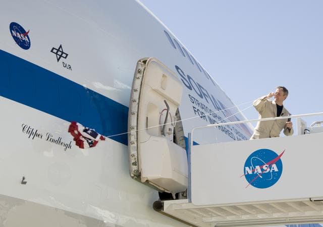 NASA image: Erik Lindbergh, grandson of famed aviator Charles Lindbergh, yanks the bunting to reveal the Clipper Lindbergh name on NASA's SOFIA 747SP on June 27, 2007