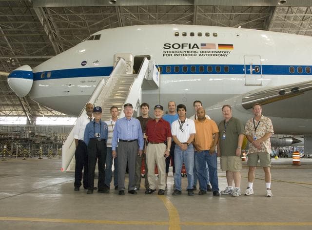 NASA image: Members of the SOFIA infrared observatory support team gather around Apollo 11 astronaut Buzz Aldrin (in red shirt) during Aldrin's tour of NASA Dryden
