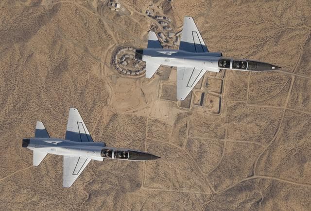 NASA image: NASA Dryden's two T-38A mission support aircraft fly in tight formation while conducting a pitot-static airspeed calibration check near Edwards Air Force Base