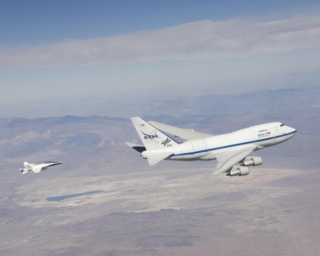 NASA image: NASA's SOFIA infrared observatory and F/A-18 safety chase during the first series of test flights to verify the flight performance of the modified Boeing 747SP