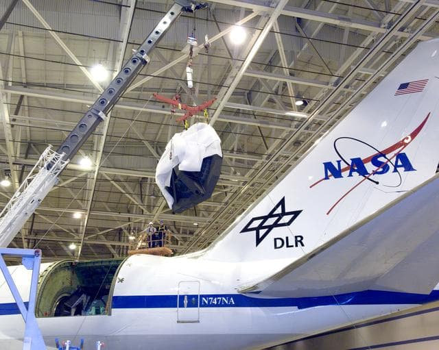 NASA image: The SOFIA primary mirror assembly is cautiously lifted from its cavity in the modified 747 by a crane in preparation for finish coating operations at NASA Ames