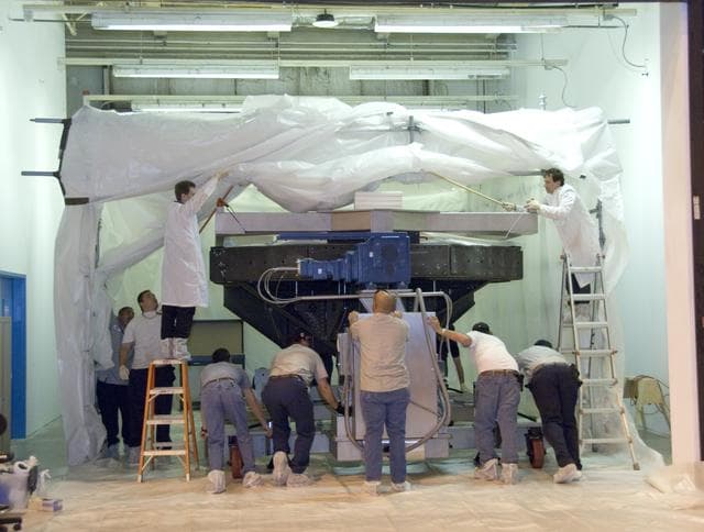 NASA image: Technicians carefully guide SOFIA's primary mirror assembly on its transport cradle into a clean room where it is being prepared for shipment to NASA Ames