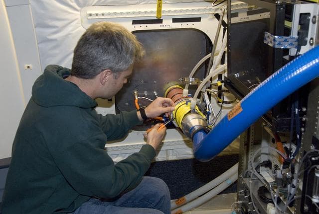 NASA image: Eric Scheuer of the University of New Hampshire installs the Soluble Acidic Gases and Aerosol instrument in NASA's DC-8 for the ARCTAS mission