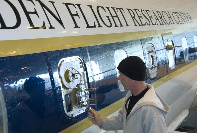 Lee Mauldin inspects the National Center for Atmospheric Research CIMS instrument probe on the exterior of NASA's DC-8 flying lab prior to the ARCTAS mission