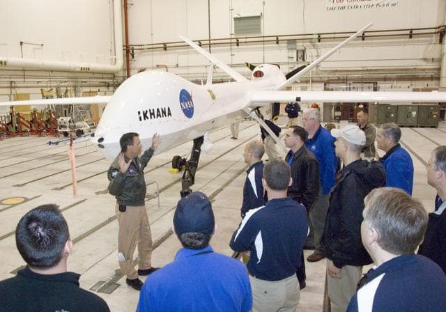 NASA image: Industrial College of the Armed Forces students on a VIP tour receive a briefing on the Ikhana unmanned air vehicle from NASA Dryden pilot Mark Pestana