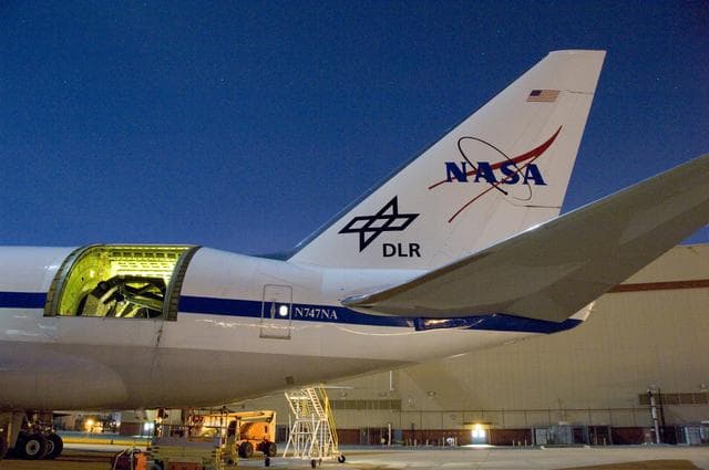 NASA image: The SOFIA airborne observatory's 2.5-meter infrared telescope peers out from its cavity in the SOFIA rear fuselage during nighttime line operations testing