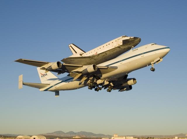 NASA image: The modified 747 carrier aircraft carrying the Space Shuttle Endeavour soars aloft from Edwards AFB on the first leg of its ferry flight back to Florida