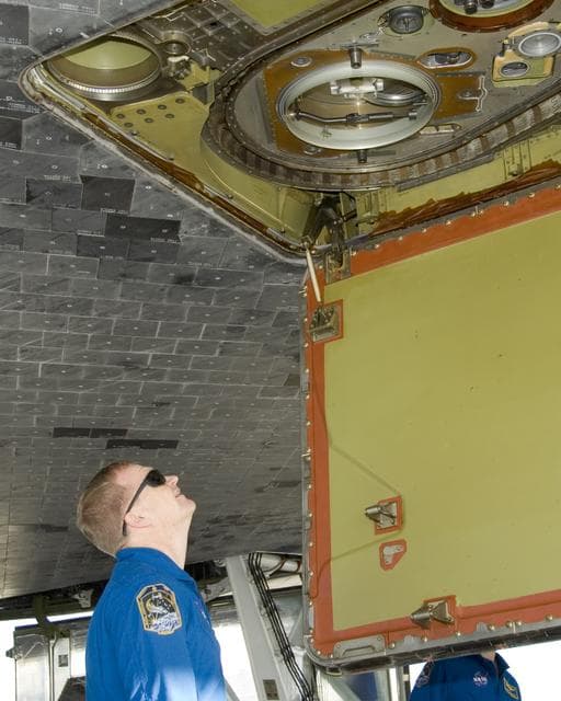 STS-126 pilot Eric Boe inspects the liquid oxygen line connection on the belly of Space Shuttle Endeavour following landing at Edwards Air Force Base Sunday