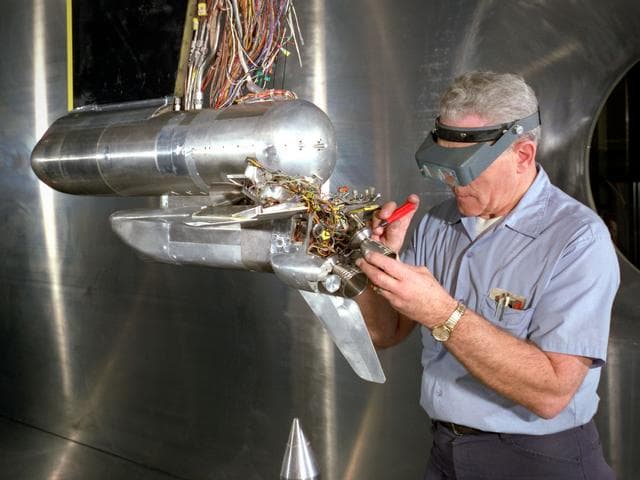 NASA image: Technician Works on a Shuttle Model in the 10- by 10-Foot Supersonic Wind Tunnel