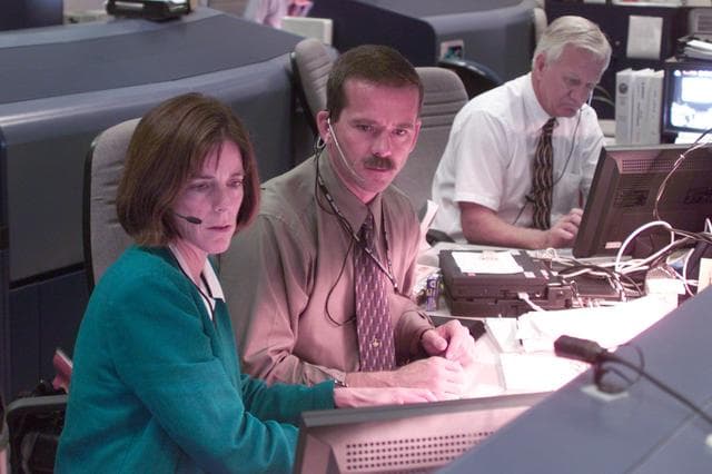 NASA image: Personnel in blue and white FCR bldg 30 during STS-106