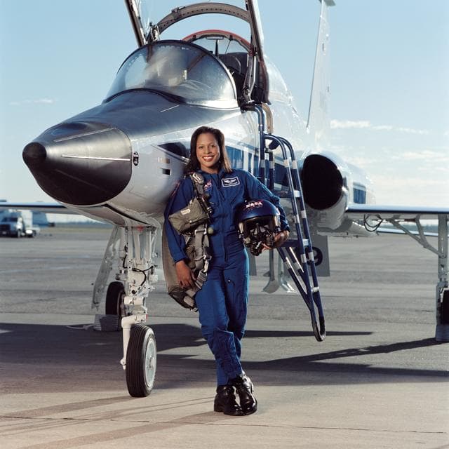 NASA image: Joan Higginbotham posing in front of a T-38 aircraft and sitting in a T-38 cockpit