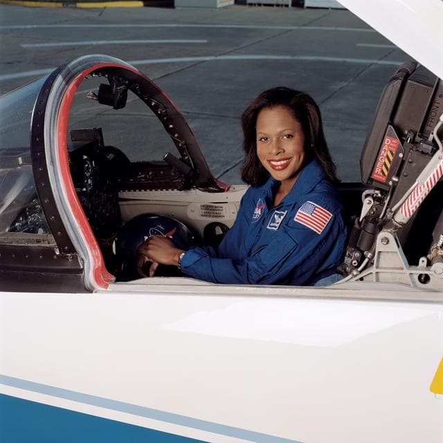 NASA image: Joan Higginbotham posing in front of a T-38 aircraft and sitting in a T-38 cockpit