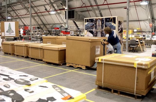 NASA image: KENNEDY SPACE CENTER, FLA. -   In the Columbia Debris Hangar, Jack Nowling moves a box filled with part of the Columbia debris.  About 83,000 pieces were shipped to KSC during search and recovery efforts in East Texas. An area of the Vehicle Assembly Building is being prepared to store the debris.