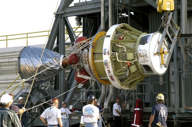 NASA image: KENNEDY SPACE CENTER, FLA. - The second stage of the Delta II rocket is raised off the transporter for its lift up the launch tower on Pad 17-A, Cape Canaveral Air Force Station.  It will be mated to the first stage in preparation for the launch of the Mars Exploration Rover 2 (MER-A).  The MER Mission consists of two identical rovers designed to cover roughly 110 yards each Martian day over various terrain. Each rover will carry five scientific instruments that will allow it to search for evidence of liquid water that may have been present in the planet’s past.  Identical to each other, the rovers will land at different regions of Mars.  Launch date for this first of NASA’s two Mars Exploration Rover missions is scheduled June 5.