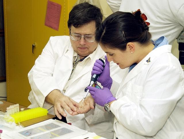 NASA image: KENNEDY SPACE CENTER, FLA. -  From left, Barry Perlman, Pembroke Pines Charter Middle School in Florida, and Valerie Cassanto, Instrumentation Technology Associates, Inc., process one of the experiments carried on mission STS-107. Several experiments were found during the search for Columbia debris. Included in the Commercial ITA Biomedical Experiments payload on mission STS-107 are urokinase cancer research, microencapsulation of drugs, the Growth of Bacterial Biofilm on Surfaces during Spaceflight (GOBBSS), and tin crystal formation.  The latter was sponsored by the Pembroke Pines Charter Middle School.