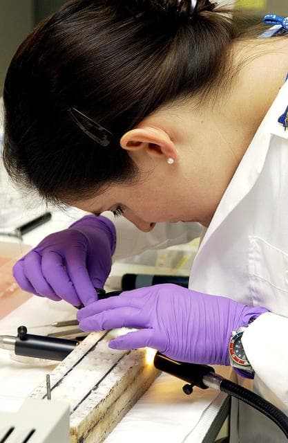 NASA image: KENNEDY SPACE CENTER, FLA. -  Valerie Cassanto, Instrumentation Technology Associates, Inc., studies one of the experiments carried on mission STS-107. Several experiments were found during the search for Columbia debris. Included in the Commercial ITA Biomedical Experiments payload on mission STS-107 are urokinase cancer research, microencapsulation of drugs, the Growth of Bacterial Biofilm on Surfaces during Spaceflight (GOBBSS), and tin crystal formation.  The latter was sponsored by the Pembroke Pines Charter Middle School.