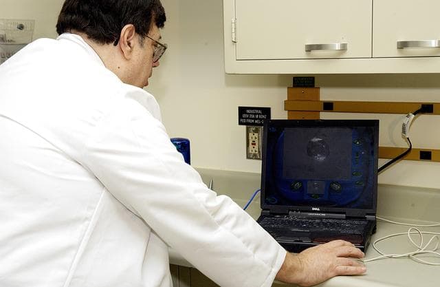 NASA image: KENNEDY SPACE CENTER, FLA. -  Barry Perlman, Pembroke Pines Charter Middle School in Florida, prepares a computer to receive data from an experiment carried on mission STS-107. Several experiments were found during the search for Columbia debris. Included in the Commercial ITA Biomedical Experiments payload on mission STS-107 are urokinase cancer research, microencapsulation of drugs, the Growth of Bacterial Biofilm on Surfaces during Spaceflight (GOBBSS), and tin crystal formation. The latter was sponsored by the Pembroke Pines Charter Middle School.