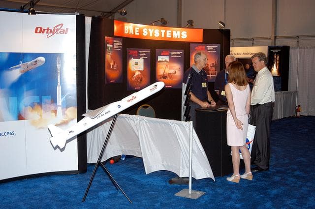 NASA image: KENNEDY SPACE CENTER, FLA. -  Visitors stop at the Orbital Sciences booth during Space Congress Week, held April 29-May 2, 2003, in Cape Canaveral, Fla.  The Space Congress is an international conference that gathers attendees from the scientific community, the space industry workforce, educators and local supporting industries.  This year's event commemorated the 40th anniversary of the Kennedy Space Center and the Centennial of Flight.  The theme for the Space Congress was "Linking the Past to the Future: A Celebration of Space."