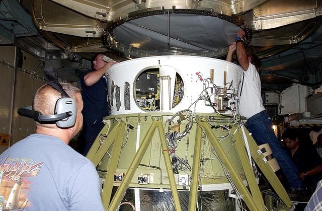 NASA image: KENNEDY SPACE CENTER, FLA. -  Workers on Launch Complex 17-B, Cape Canaveral Air Force Station, start dismantling the Space Infrared Telescope Facility (SIRTF) observatory from atop the Delta II rocket.  It will be taken back to NASA Spacecraft Hangar AE. SIRTF will remain in the clean room at Hangar AE until it returns to the pad in early August.