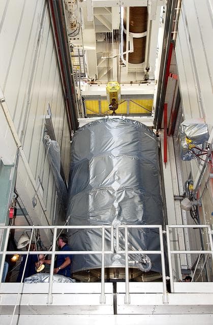NASA image: KENNEDY SPACE CENTER, FLA. - On Launch Complex 17-B, Cape Canaveral Air Force Station, the Space Infrared Telescope Facility (SIRTF) observatory is moved toward the outside of the launch tower.  It will be lowered and taken back to NASA Spacecraft Hangar AE. SIRTF will remain in the clean room at Hangar AE until it returns to the pad in early August.